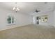 Spacious living room with carpet flooring, neutral walls, and sliding glass doors leading to the outdoors at 3309 Raleigh Dr, Winter Haven, FL 33884