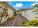 Landscaped side yard with a brick pathway and lush plants at 3309 Raleigh Dr, Winter Haven, FL 33884