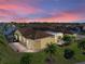 Backyard view of house at sunset with screened patio and solar panels at 3604 Blackmoor Ln, Lake Wales, FL 33859
