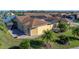 House with solar panels, screened patio, and lush landscaping at 3604 Blackmoor Ln, Lake Wales, FL 33859