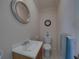 Small bathroom with toilet, sink, and mirror at 3604 Blackmoor Ln, Lake Wales, FL 33859