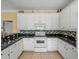 Bright kitchen with white cabinets, granite countertops, and modern appliances at 3604 Blackmoor Ln, Lake Wales, FL 33859