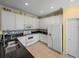 Modern kitchen with white cabinets, granite countertops, and stainless steel appliances at 3604 Blackmoor Ln, Lake Wales, FL 33859
