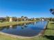 Community lake with houses and lush landscaping at 3604 Blackmoor Ln, Lake Wales, FL 33859