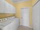 Laundry room with washer, dryer, and cabinets at 3604 Blackmoor Ln, Lake Wales, FL 33859