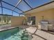 Pool area with grill and covered patio at 3604 Blackmoor Ln, Lake Wales, FL 33859