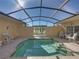 Private screened pool with tiled deck and seating at 3604 Blackmoor Ln, Lake Wales, FL 33859