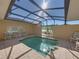 Private screened pool with tiled deck and seating at 3604 Blackmoor Ln, Lake Wales, FL 33859