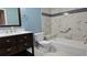 Bathroom with dark brown vanity, white toilet and bathtub, marble tile at 4121 Fishermans Lndg, Winter Haven, FL 33884