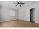 Bedroom with ceiling fan, closet, and light wood flooring at 501 Arneson Ave, Auburndale, FL 33823