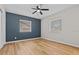 Spacious bedroom with ceiling fan, new flooring, and two windows at 501 Arneson Ave, Auburndale, FL 33823