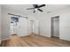 Bedroom with barn door entry to bathroom and ceiling fan at 501 Arneson Ave, Auburndale, FL 33823