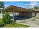 Covered carport next to house entrance at 501 Arneson Ave, Auburndale, FL 33823