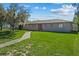 Ranch style home with carport, well-manicured lawn, and walkway at 501 Arneson Ave, Auburndale, FL 33823