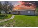 House exterior with a beautiful lawn and walkway at 501 Arneson Ave, Auburndale, FL 33823