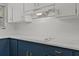 White quartz countertops and blue cabinets in renovated kitchen at 501 Arneson Ave, Auburndale, FL 33823