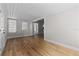 Light and airy living room with hardwood floors and access to other rooms at 501 Arneson Ave, Auburndale, FL 33823