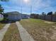 Front view of a single-story home with a yard at 102 Luna Rd, Auburndale, FL 33823