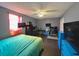 Bedroom with a bed, two large TVs, and a desk at 1082 Sunshine Sw Way, Winter Haven, FL 33880