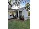 Charming house with gray siding, a covered porch, and landscaping at 1082 Sunshine Sw Way, Winter Haven, FL 33880