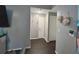 Gray hallway with dark hardwood floors and linen closet at 1082 Sunshine Sw Way, Winter Haven, FL 33880