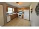 Galley kitchen with white appliances and wood cabinets at 1082 Sunshine Sw Way, Winter Haven, FL 33880