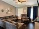 Spacious living room with sectional sofa, recliner, and dark hardwood floors at 1082 Sunshine Sw Way, Winter Haven, FL 33880