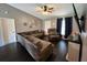 Living room featuring sectional sofa, recliner, and ceiling fan at 1082 Sunshine Sw Way, Winter Haven, FL 33880