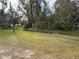 Grass yard with trees and vegetation at 1322 Shady Cove W Rd, Haines City, FL 33844