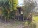 Wooden home with a porch and lush greenery at 1322 Shady Cove W Rd, Haines City, FL 33844