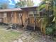 Wooden home with steps and a palm tree nearby at 1322 Shady Cove W Rd, Haines City, FL 33844