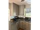 Gray kitchen cabinets, granite countertops, and stainless steel dishwasher at 1322 Shady Cove W Rd, Haines City, FL 33844