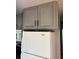 White Whirlpool refrigerator with gray upper cabinets at 1322 Shady Cove W Rd, Haines City, FL 33844