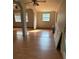 Bright living room with hardwood floors and ceiling fan at 1322 Shady Cove W Rd, Haines City, FL 33844