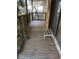 Wooden deck porch with railing and metal step at 1322 Shady Cove W Rd, Haines City, FL 33844