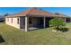 Tan house with brown roof and screened lanai at 1340 Oakmont Dr, Winter Haven, FL 33884