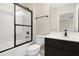 Clean bathroom with tub shower combo, toilet and dark vanity at 137 Drayton Ave, Davenport, FL 33837