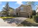 Two-story house with stone accents and a large driveway at 137 Drayton Ave, Davenport, FL 33837