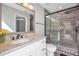 Elegant bathroom with a walk-in shower and granite vanity at 1591 Forest Hills Ln, Haines City, FL 33844