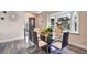 Bright dining room with glass table and bay window at 1591 Forest Hills Ln, Haines City, FL 33844