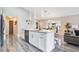 Modern kitchen with white cabinets, granite countertops, and island at 1591 Forest Hills Ln, Haines City, FL 33844