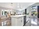 Modern kitchen with white cabinets, granite countertops, and island at 1591 Forest Hills Ln, Haines City, FL 33844