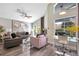 Spacious living room with sectional sofa, large window, and hardwood floors at 1591 Forest Hills Ln, Haines City, FL 33844