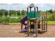 playground with slide and climbing structures near a lake at 1591 Forest Hills Ln, Haines City, FL 33844