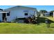 Side view of home with AC unit and yard at 161 Bonnie Dr, Auburndale, FL 33823