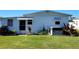 Side view of home with AC unit and yard at 161 Bonnie Dr, Auburndale, FL 33823