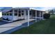 Side view of a white mobile home with carport and well-maintained lawn at 161 Bonnie Dr, Auburndale, FL 33823