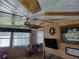 Sunroom with wood-paneled walls, ceiling fan, and nautical decor at 161 Bonnie Dr, Auburndale, FL 33823