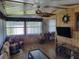 Bright sunroom features wicker furniture and wood flooring at 161 Bonnie Dr, Auburndale, FL 33823