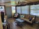Comfortable sunroom with wicker furniture and wood floors at 161 Bonnie Dr, Auburndale, FL 33823